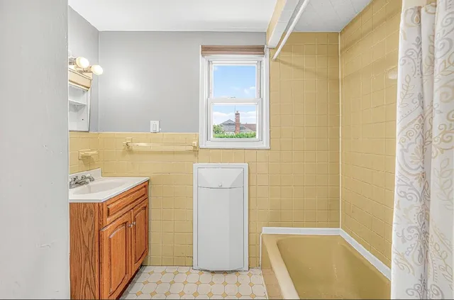 a bathroom with a sink a bathtub and a shower