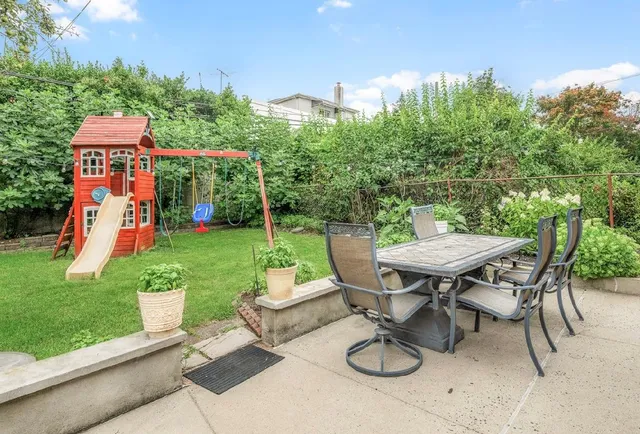 a view of a chairs and table in patio of the house