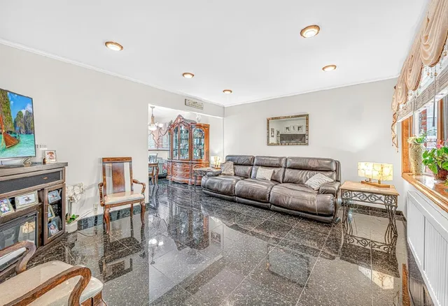 a living room with furniture wooden floor and a large window