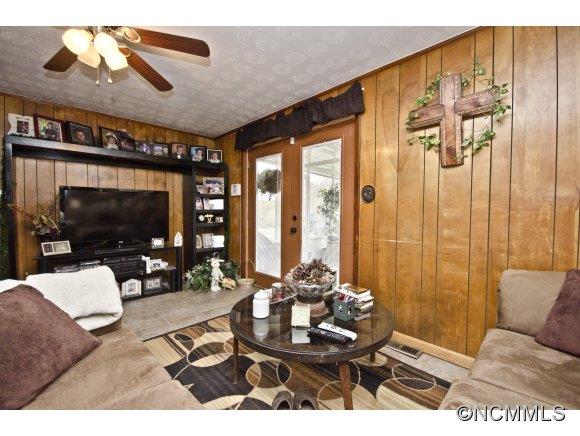 58 Ponder Farm Road Marshall, NC 28753 - Photo 8 of 20 a living room with furniture a flat screen tv and a large window