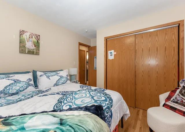 a bedroom with a large bed and a window