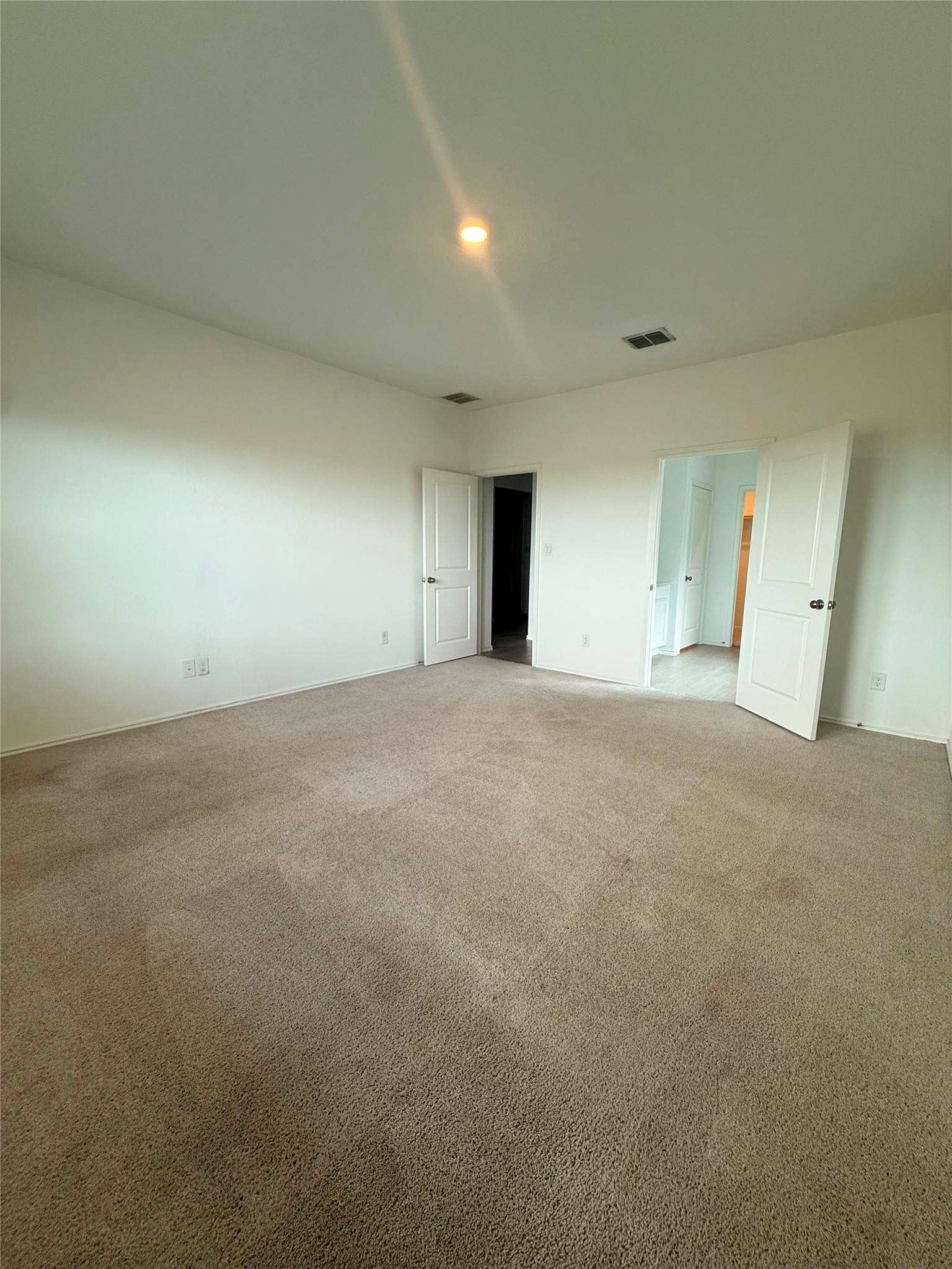 192 Rodney Boat Road Kyle, TX 78640 - Photo 37 of 40 A spacious room offers comfortable carpet flooring and abundant natural light.