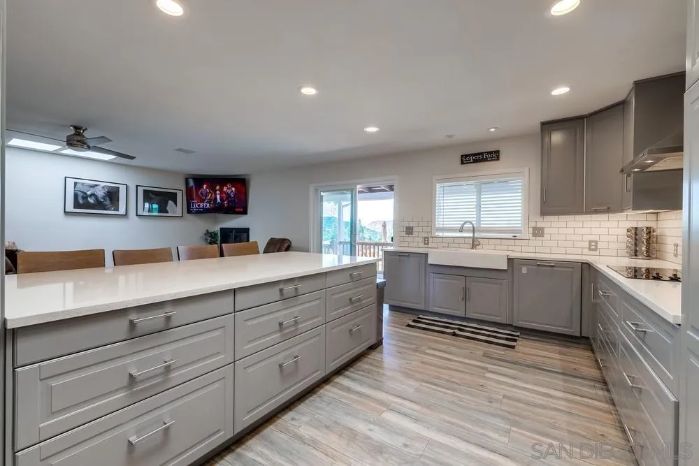 1125 South Grade Road Alpine, CA 91901 - Photo 14 of 50 a large kitchen with stainless steel appliances granite countertop a lot of counter space and wooden floors