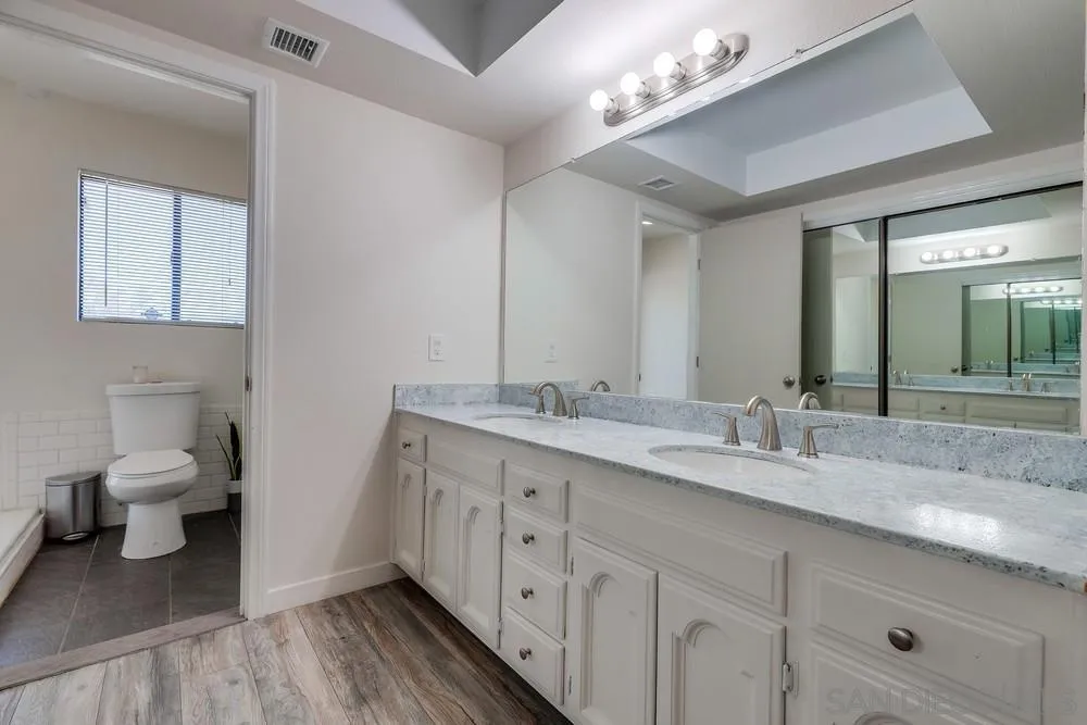 1125 South Grade Road Alpine, CA 91901 - Photo 24 of 50 a bathroom with a double vanity sink and a toilet