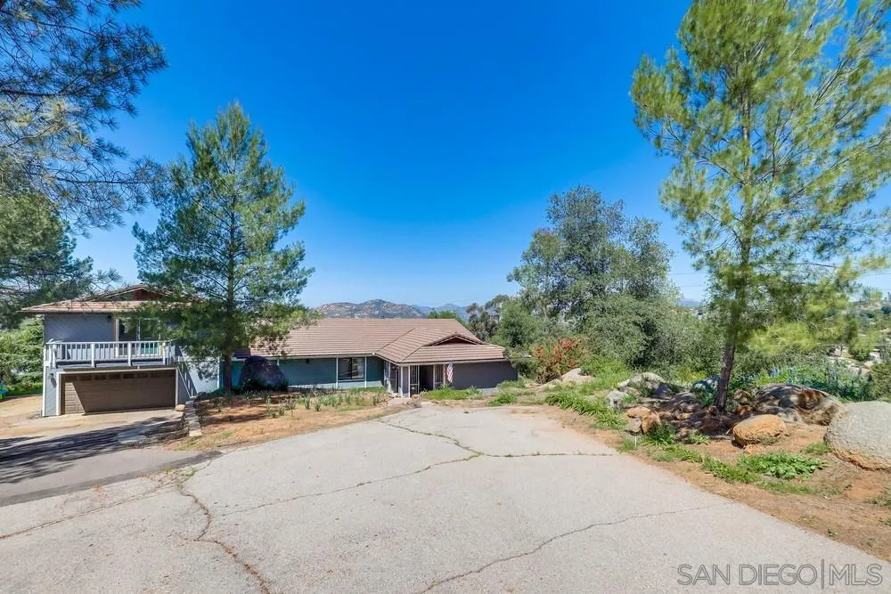 1125 South Grade Road Alpine, CA 91901 - Photo 4 of 50 a front view of a house with a yard and garage