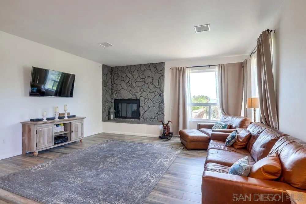 1125 South Grade Road Alpine, CA 91901 - Photo 8 of 50 a living room with furniture a flat screen tv and a fireplace