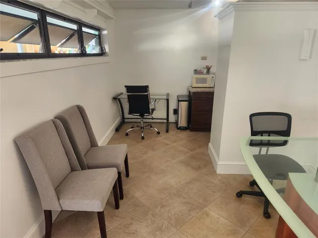 a living room with furniture and a chair