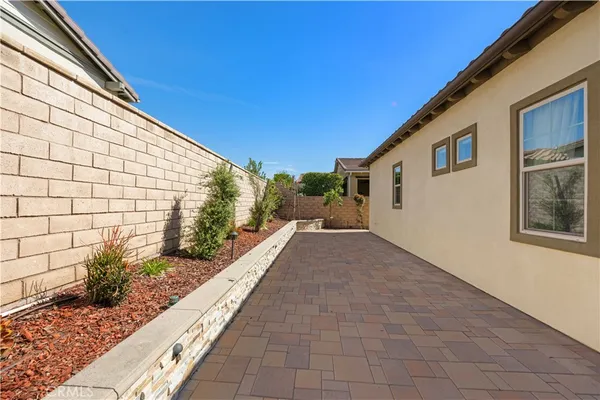 a view of a patio with couches and potted plants