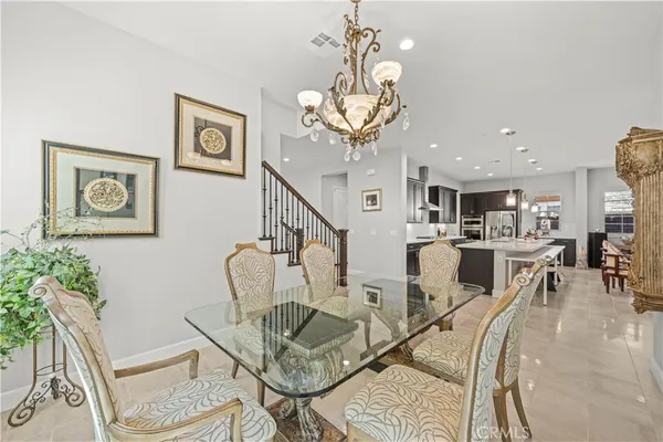 a kitchen with stainless steel appliances granite countertop a sink a stove and a refrigerator