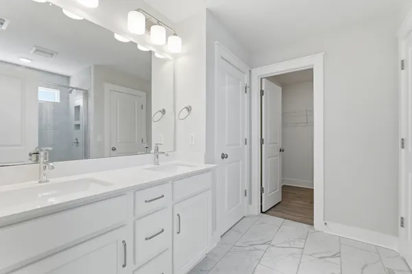 a bathroom with a double vanity sink and a mirror