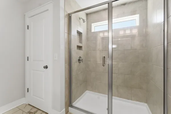 a bathroom with a glass shower door