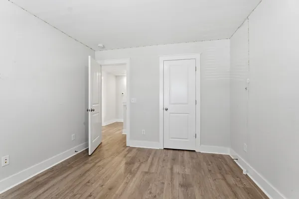 a view of an empty room and wooden floor