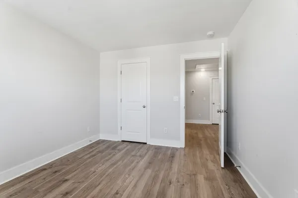 a view of a room with wooden floor
