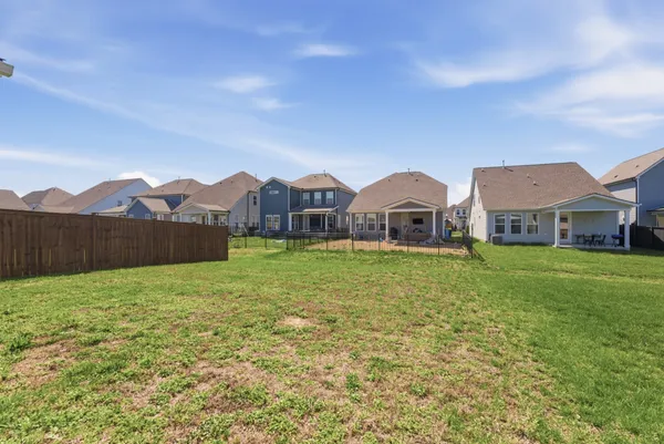 a front view of house with yard and mountain view in back