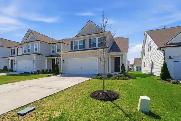a front view of a house with a yard