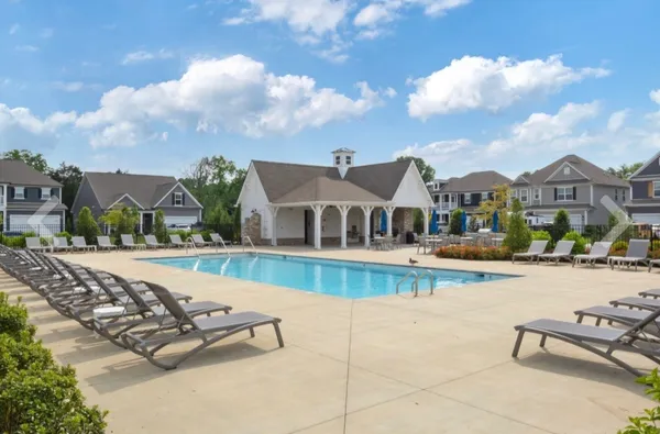a view of a house with swimming pool and sitting area