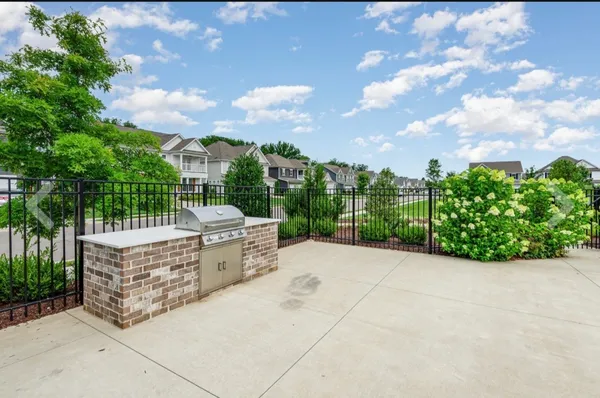 a view of a garden with iron fence
