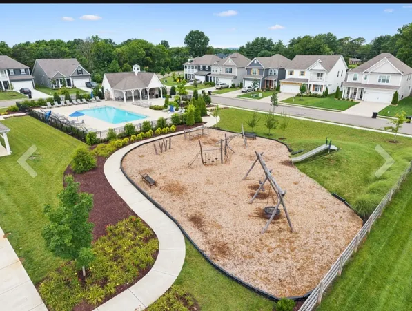 an aerial view of a house with a garden and swimming pool