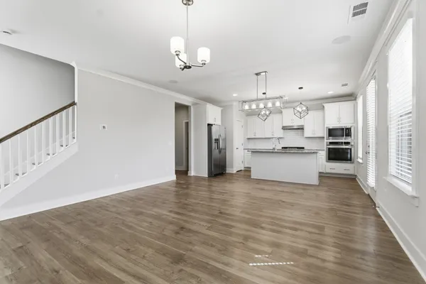 a view of a kitchen with a sink wooden floor and a kitchen