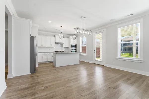 a view of a kitchen with wooden floor