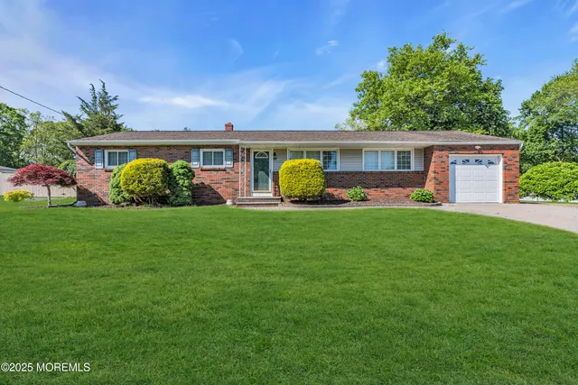 a front view of house with yard and green space
