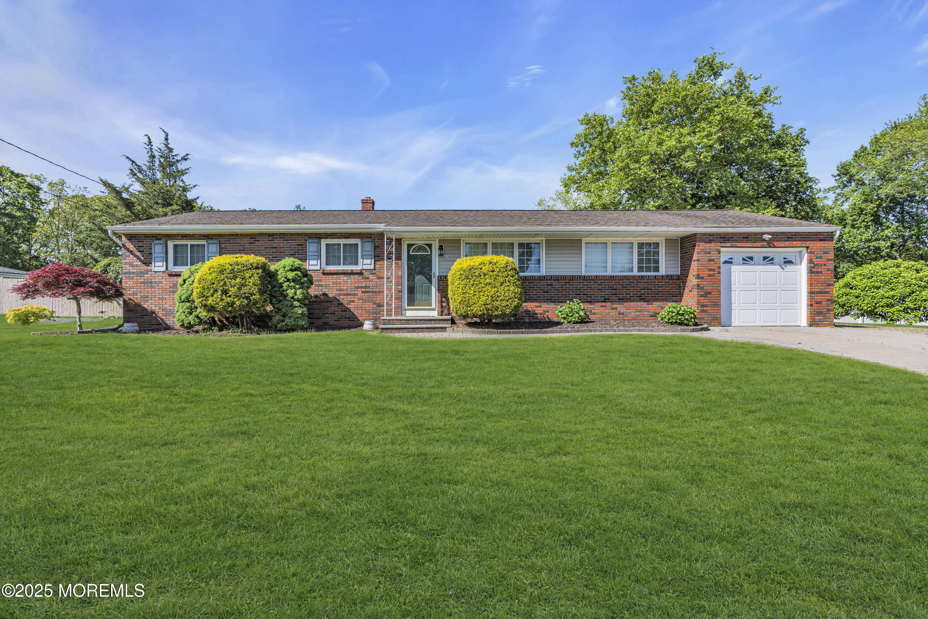 a front view of house with yard and green space
