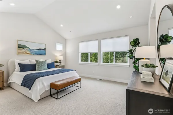 a spacious bedroom with a bed and window