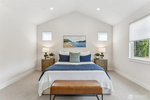 a bed sitting in a bedroom next to a window