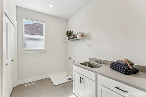 a kitchen with a sink and cabinets