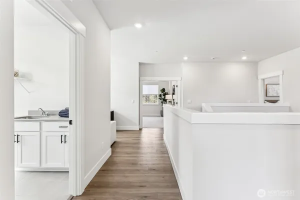 a view of a hallway with wooden floor