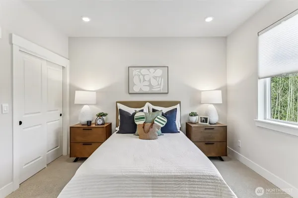 a bed room with a bed and a night stand