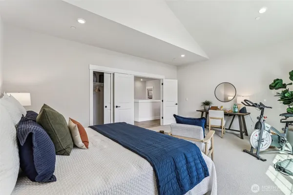 a bedroom with a bed and chandelier