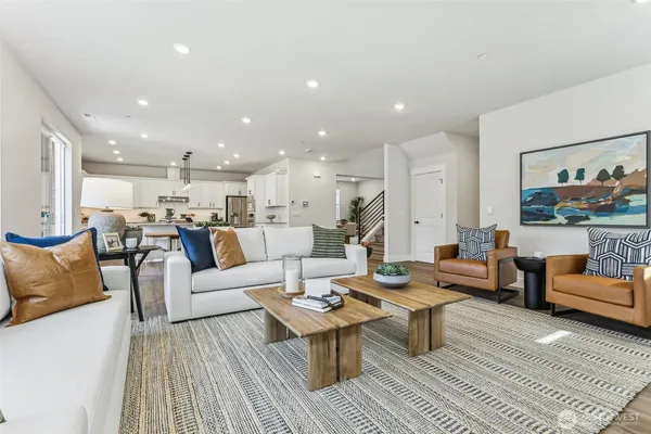 a living room with furniture kitchen view and a table
