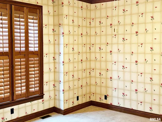 a view of a hallway with wooden floor and cabinet