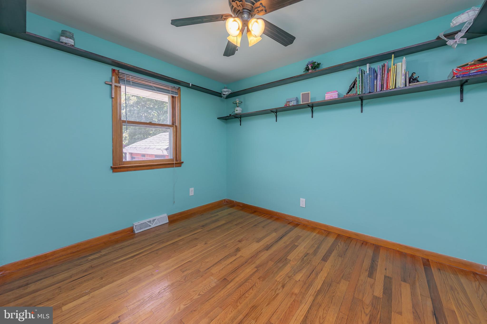 121 Kansas Road Pennsville, NJ 08070 - Photo 13 of 32 wooden floor in an empty room with a window