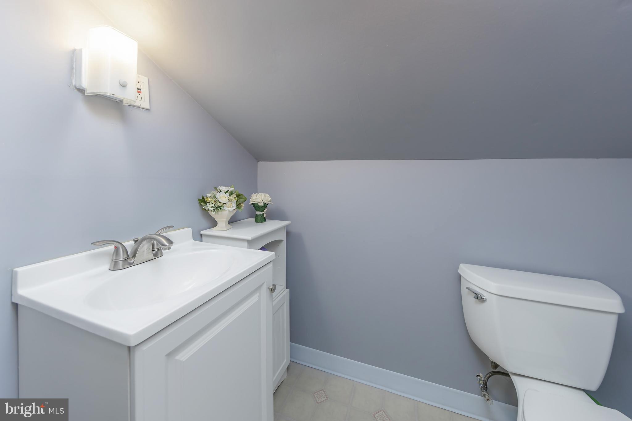 121 Kansas Road Pennsville, NJ 08070 - Photo 18 of 32 a bathroom with a toilet sink and mirror