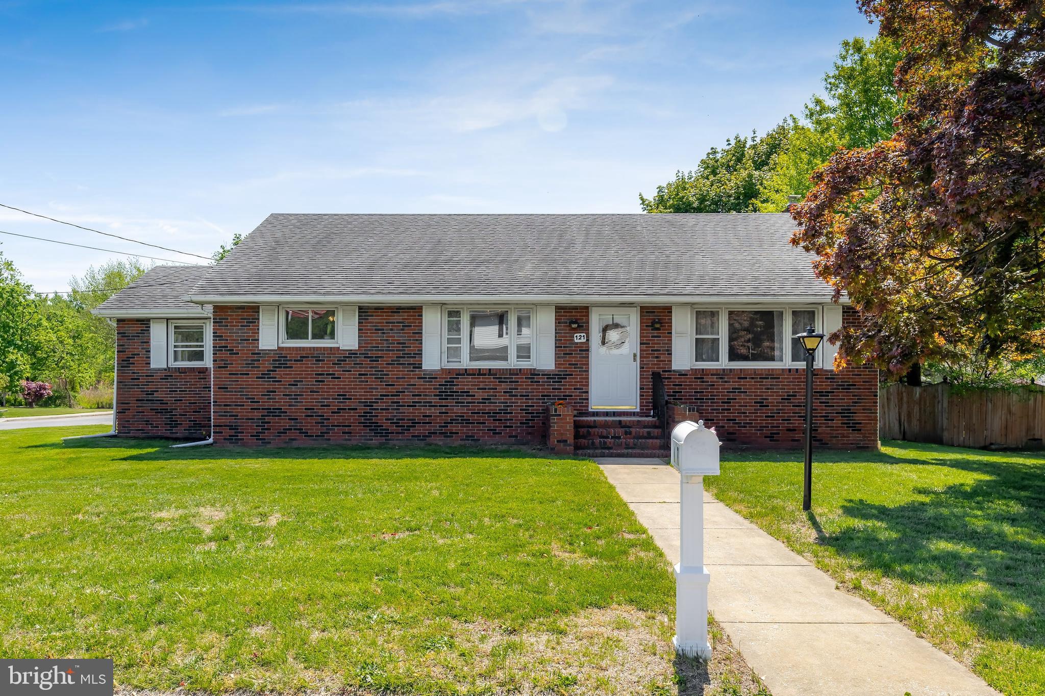 121 Kansas Road Pennsville, NJ 08070 - Photo 2 of 32 a front view of a house with a yard and garage