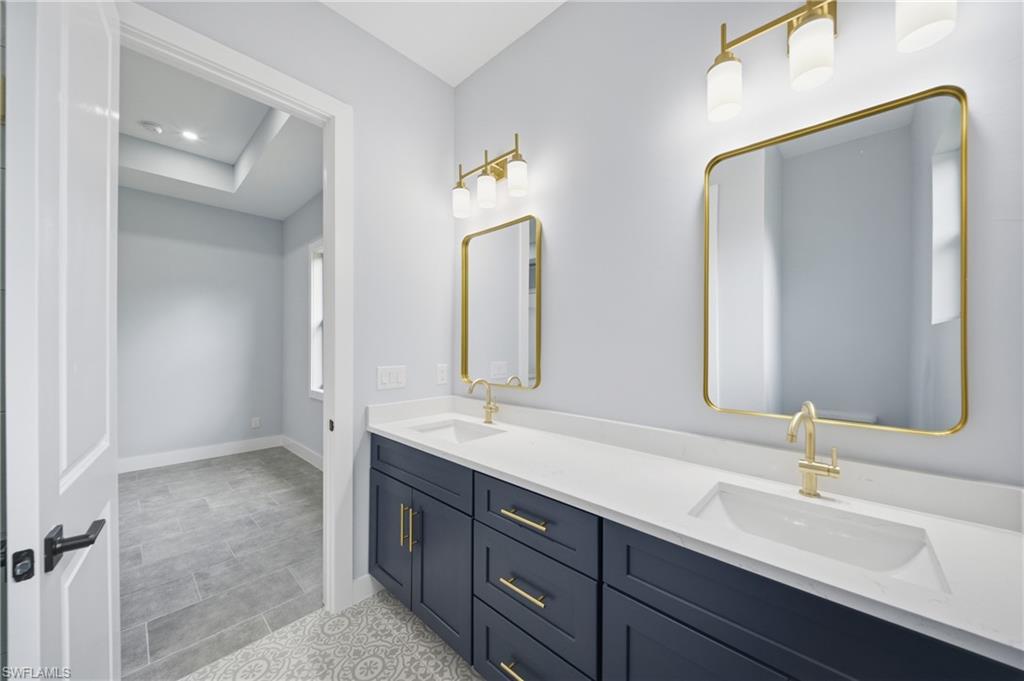 19871 Adams Road Fort Myers, FL 33908 - Photo 14 of 25 Bathroom featuring double vanity and baseboards