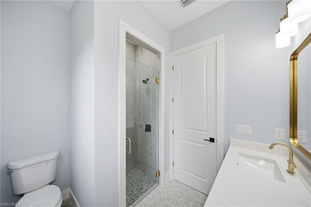 19871 Adams Road Fort Myers, FL 33908 - Photo 15 of 25 Bathroom with vanity and a shower stall