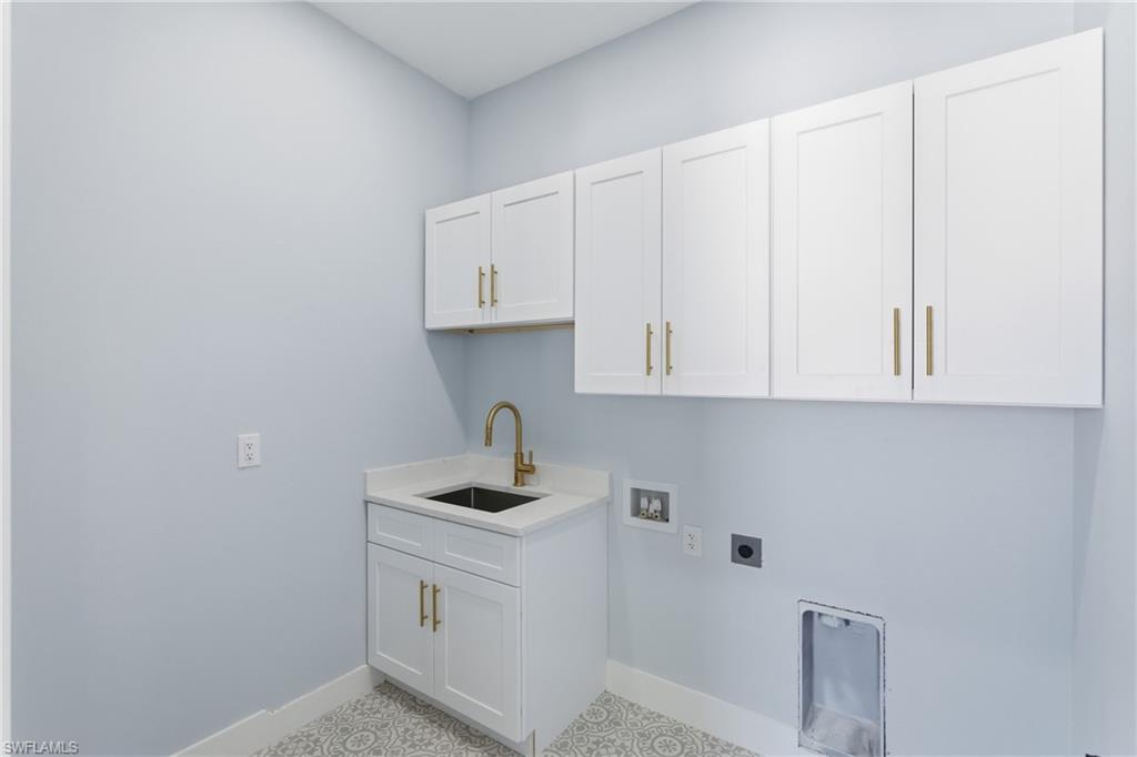 19871 Adams Road Fort Myers, FL 33908 - Photo 20 of 25 Laundry area with cabinet space, washer hookup, and hookup for an electric dryer