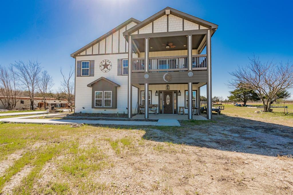 a front view of a house with swimming pool having outdoor seating