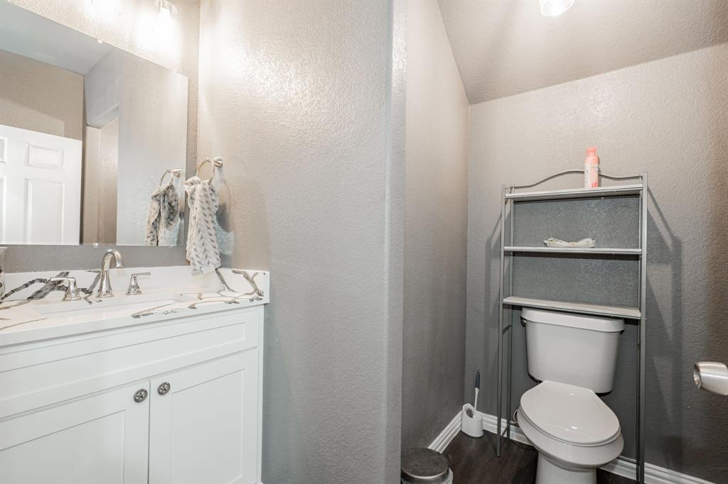 641 Countess Road Quinlan, TX 75474 - Photo 19 of 35 a bathroom with a toilet a sink and mirror