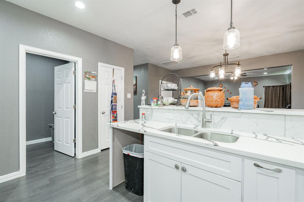 641 Countess Road Quinlan, TX 75474 - Photo 21 of 35 a view of a kitchen center island wooden floor and a chandelier