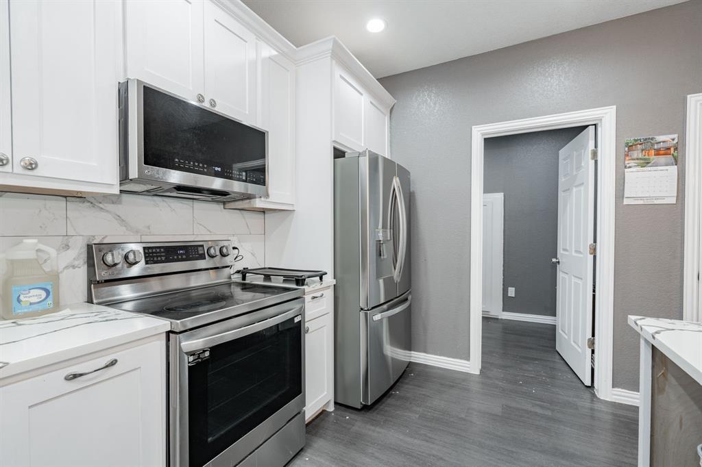 641 Countess Road Quinlan, TX 75474 - Photo 22 of 35 a kitchen with a stove microwave and refrigerator