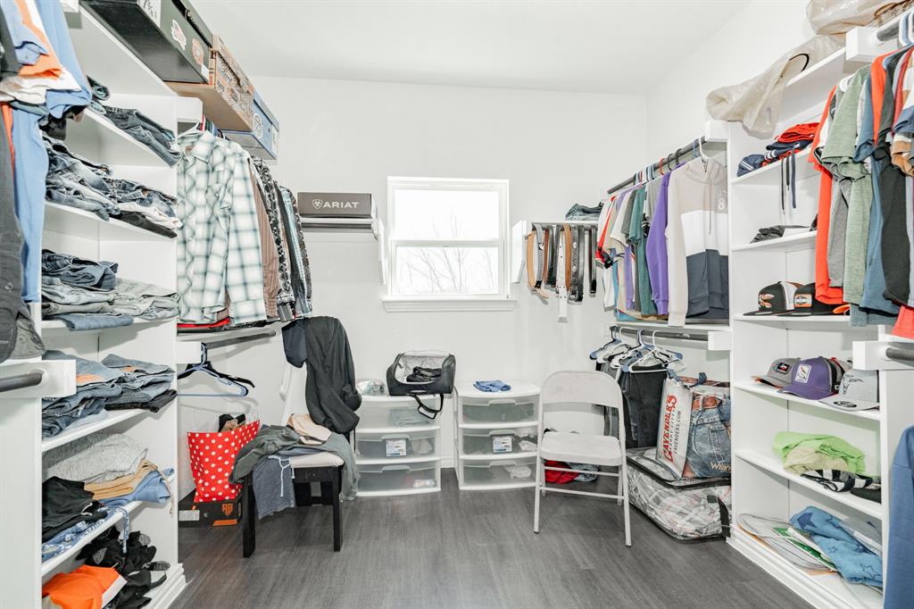 641 Countess Road Quinlan, TX 75474 - Photo 3 of 35 a view of walk in closet with clothes and shoes