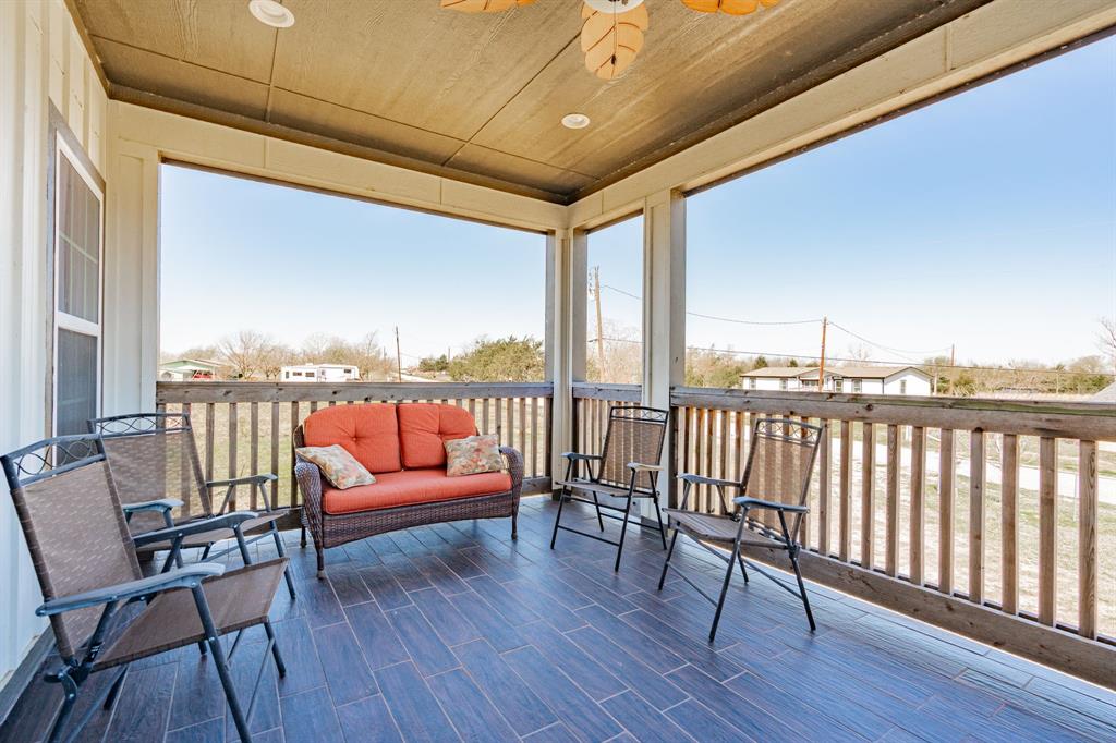 641 Countess Road Quinlan, TX 75474 - Photo 32 of 35 a balcony with chairs and wooden floor