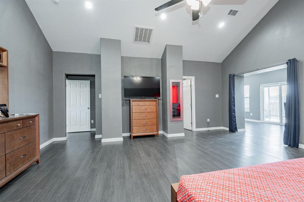 641 Countess Road Quinlan, TX 75474 - Photo 8 of 35 a view of a livingroom with wooden floor and a kitchen space