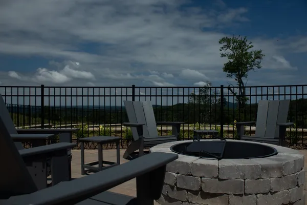 a roof deck with table and chairs a barbeque