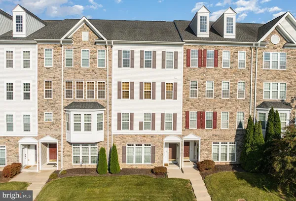 a front view of a residential apartment building with a yard