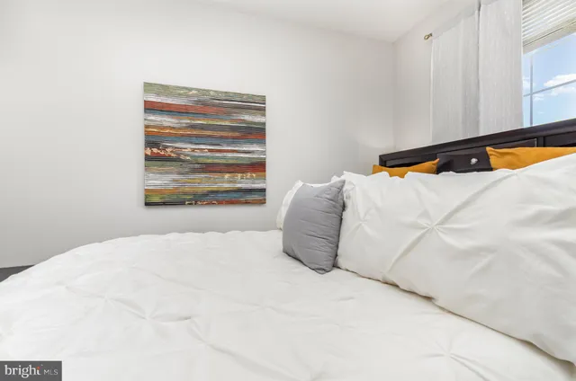 a bedroom with a bed and window